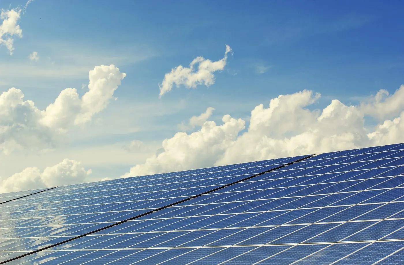 Solar panels on a roof under a blue sky — typical residential photovoltaic array