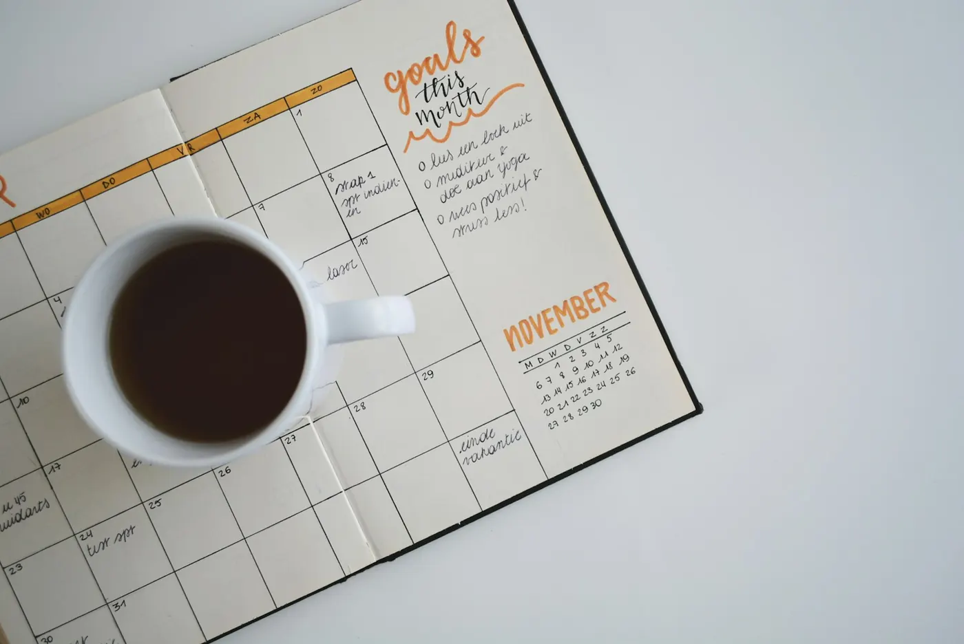 Open monthly planner with coffee — thinking in decades, not in today’s discount