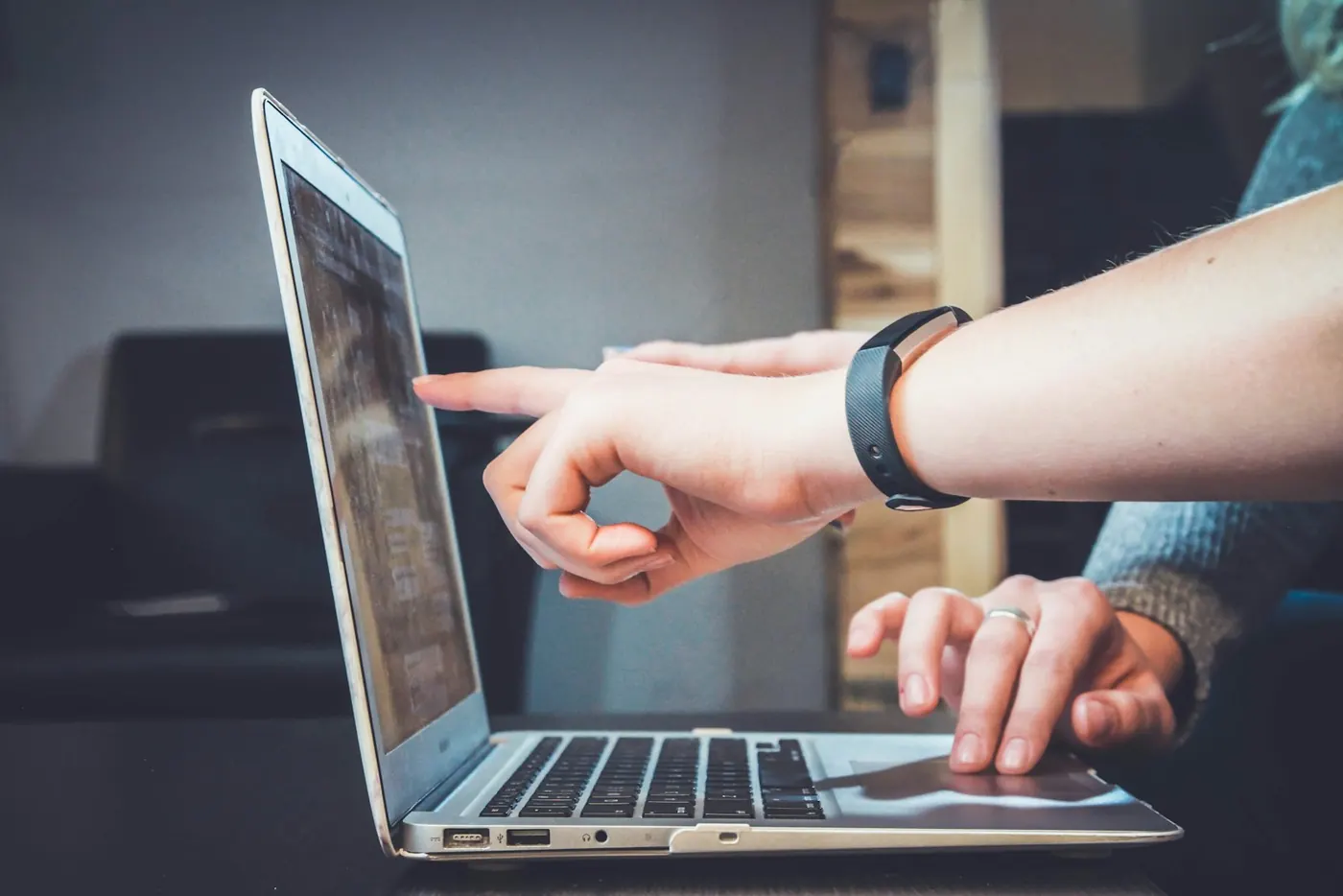 Person comparing information on a laptop